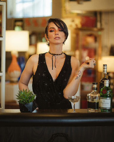 female bartender looking stressed in front of customers
