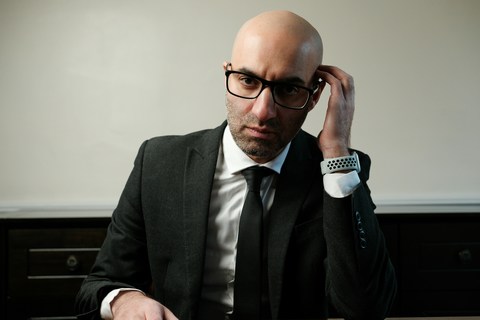 professional man in glasses looking serious and unhappy