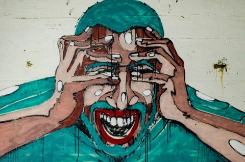 abstract painting of man screaming in frustration with hands on face