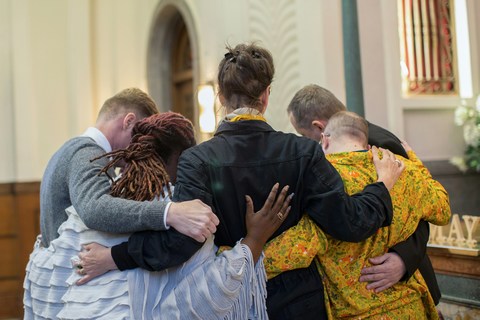 Supportive community at a New York City funeral