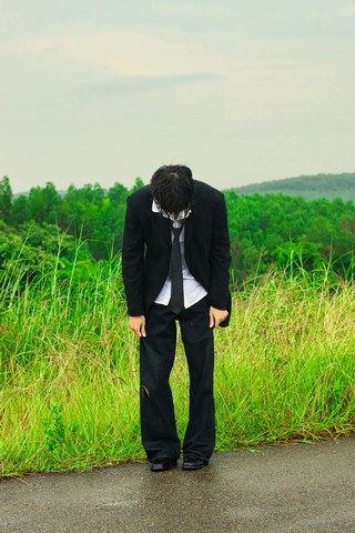 emotionally exhausted man looking intently at other man