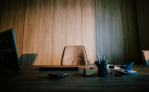 empty office chair and desk showing worker who quit job