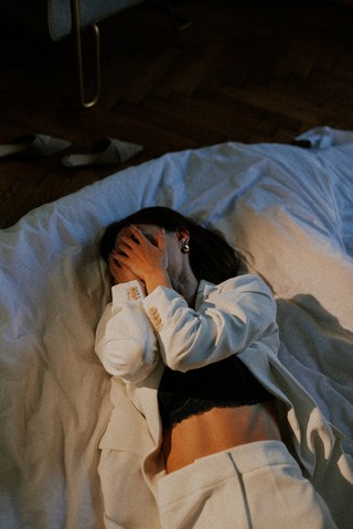 woman who is filled with work stress with hands over face